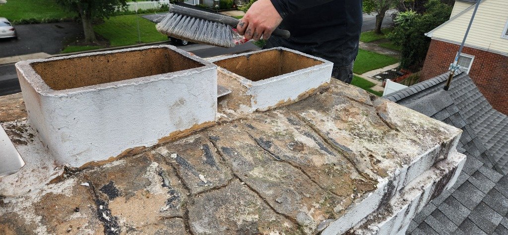Technician sweeping a chimney
